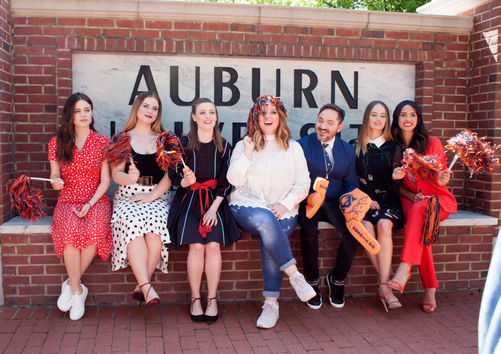 Sitting on the Auburn University sign